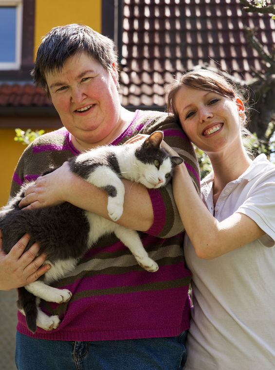 disabled woman with caregiver and cat